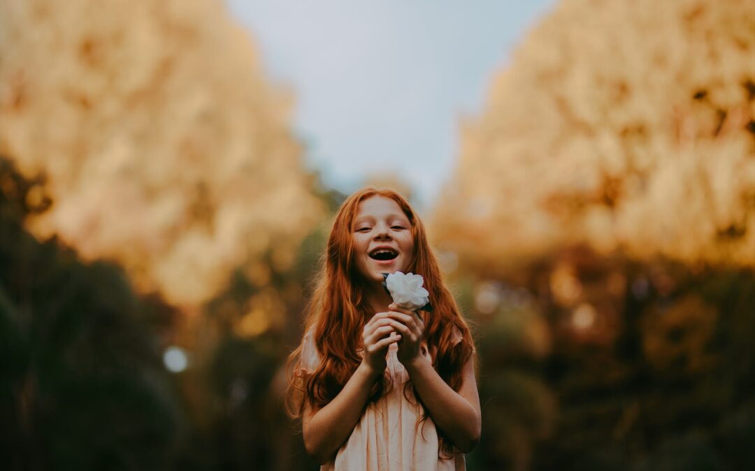 girl holding white flower