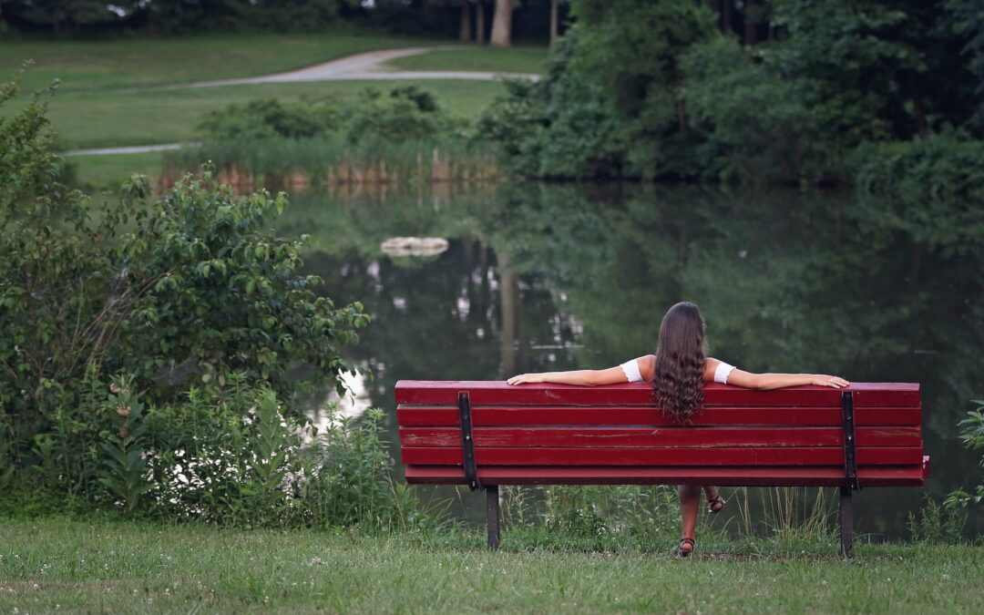 photography of woman relaxing on bench