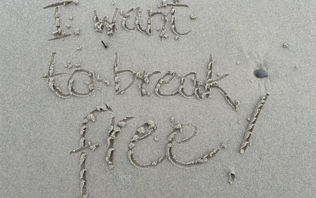 i want to break free written in the sand
