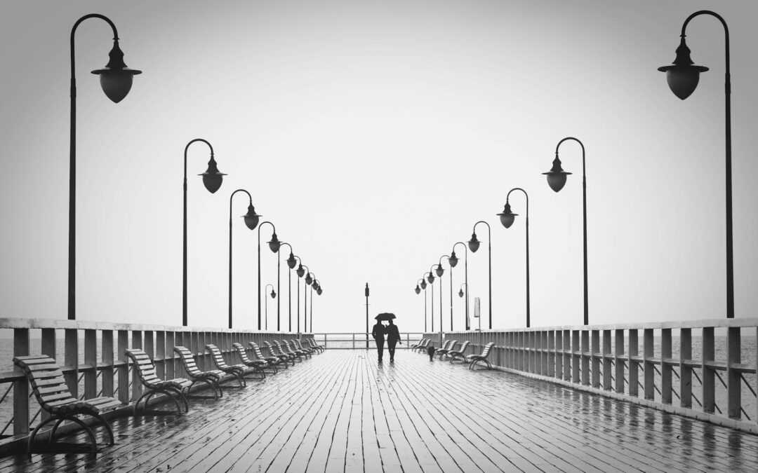 two people walking on pier