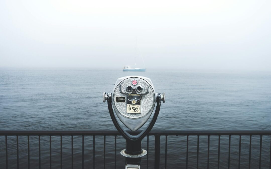 telescope in front of body of water