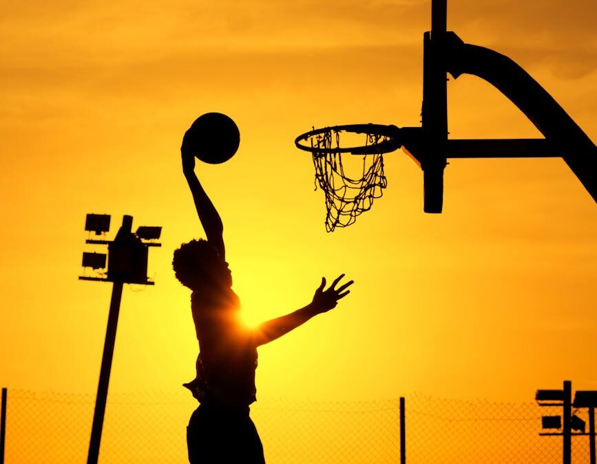 silhouette of basketball player at sunset